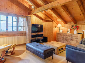 Experience the charm of this cozy living space, featuring a warm wooden interior and a stunning view from the large windows.