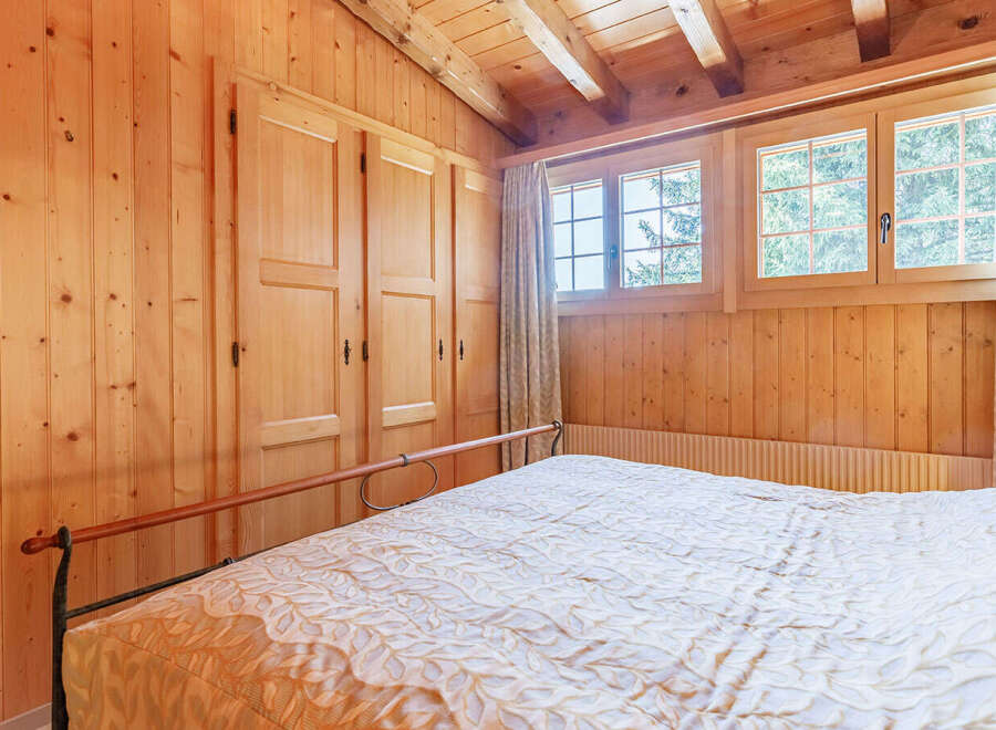 This cozy bedroom features beautiful wood paneling throughout, creating a warm and inviting atmosphere.