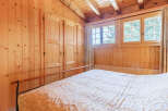 This cozy bedroom features beautiful wood paneling throughout, creating a warm and inviting atmosphere.