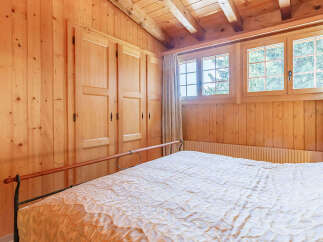 This cozy bedroom features beautiful wood paneling throughout, creating a warm and inviting atmosphere.