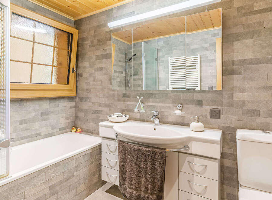 This stunning bathroom features a modern design with a sleek white sink and vanity.