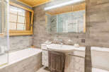 This stunning bathroom features a modern design with a sleek white sink and vanity.