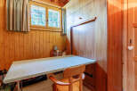This charming room features a built-in desk and a fold-down bed, maximizing space and functionality.