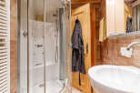 Step into this inviting bathroom, featuring a modern shower enclosure and a sleek, white sink.