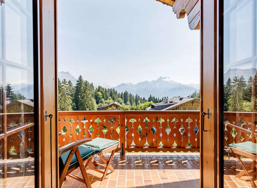 Experience breathtaking mountain views from this charming balcony.