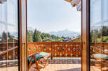 Experience breathtaking mountain views from this charming balcony.