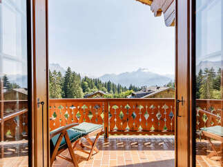 Experience breathtaking mountain views from this charming balcony.
