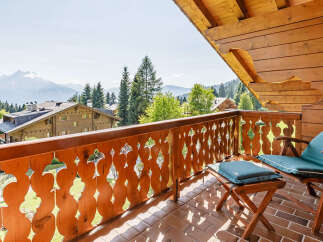 Enjoy breathtaking mountain views from this charming balcony.