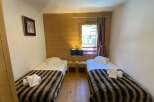 This cozy bedroom features two twin beds, perfect for a comfortable stay.