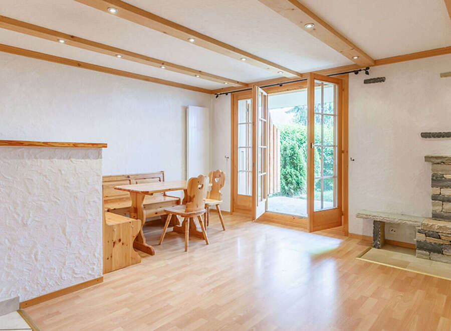 This charming property features a cozy living space with a rustic fireplace, perfect for relaxing evenings.