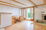 This charming property features a cozy living space with a rustic fireplace, perfect for relaxing evenings.