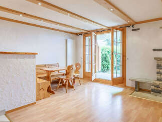 This charming property features a cozy living space with a rustic fireplace, perfect for relaxing evenings.