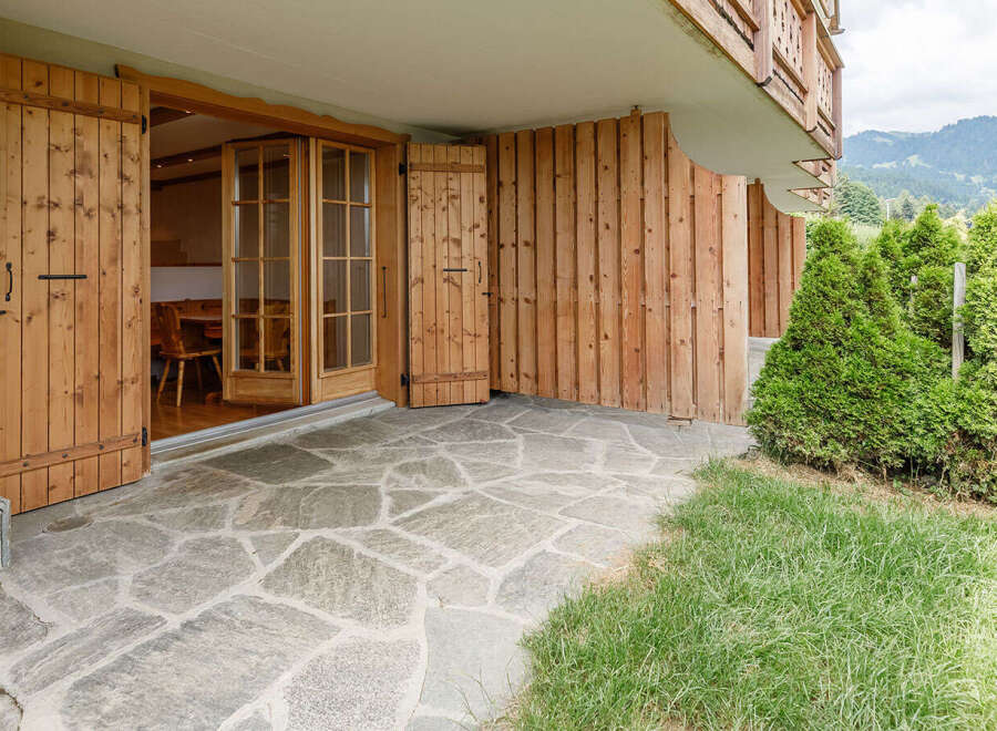Discover the charm of this property, featuring a beautiful stone patio that leads to a cozy interior.