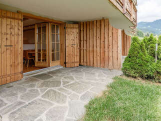 Discover the charm of this property, featuring a beautiful stone patio that leads to a cozy interior.