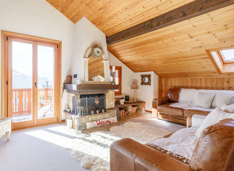 This charming property boasts a cozy living room with a rustic fireplace, perfect for those chilly evenings.