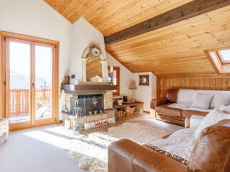 This charming property boasts a cozy living room with a rustic fireplace, perfect for those chilly evenings.