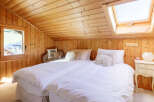 Step into this cozy bedroom featuring a charming wooden interior, creating a warm and inviting atmosphere.