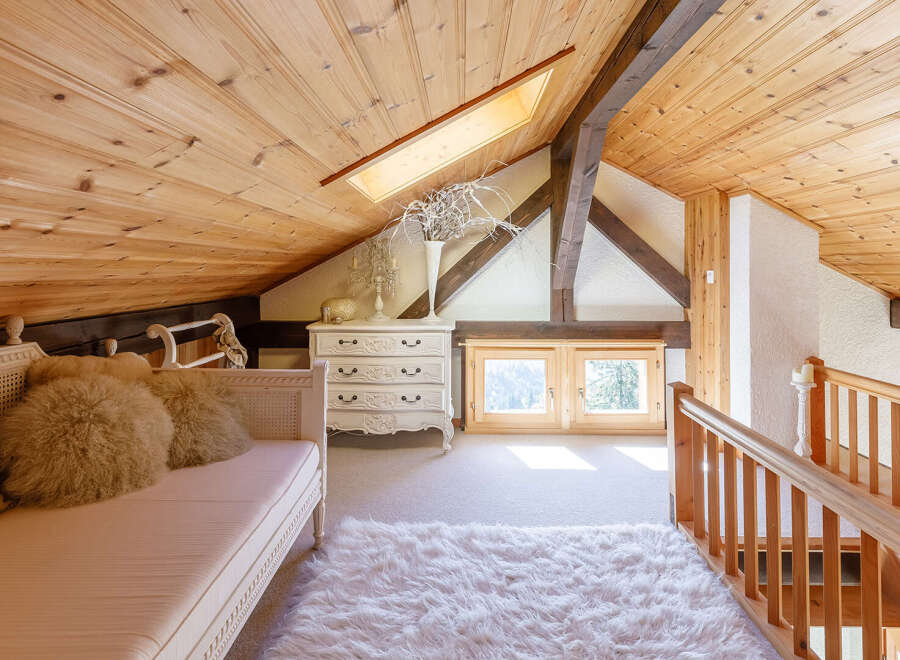 This charming attic space boasts a cozy and inviting atmosphere, perfect for relaxation.
