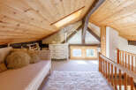 This charming attic space boasts a cozy and inviting atmosphere, perfect for relaxation.