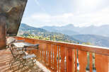 Enjoy breathtaking mountain views from this charming balcony.