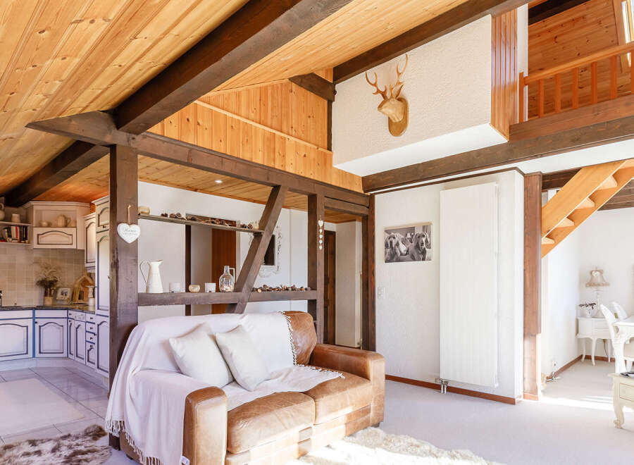 This stunning property boasts a unique architectural design with exposed wooden beams and a cozy, inviting atmosphere.