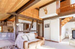 This stunning property boasts a unique architectural design with exposed wooden beams and a cozy, inviting atmosphere.