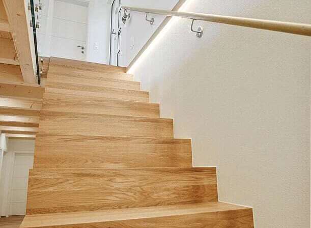 This stunning property features a beautifully crafted wooden staircase, adding warmth and elegance to the interior.
