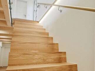 This stunning property features a beautifully crafted wooden staircase, adding warmth and elegance to the interior.