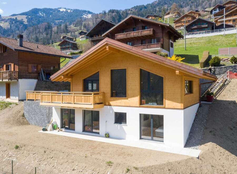This stunning wooden chalet offers a modern design with a touch of rustic charm.