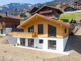 This stunning wooden chalet offers a modern design with a touch of rustic charm.