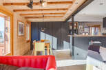 This stunning property boasts a warm and inviting interior with exposed wooden beams and paneling, creating a cozy atmosphere.