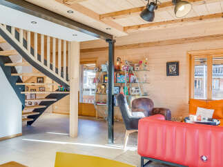 This stunning property boasts a modern interior with a unique wooden design, creating a warm and inviting atmosphere.