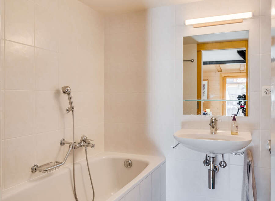 This charming bathroom features a bright and airy design, perfect for relaxation.