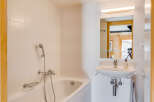 This charming bathroom features a bright and airy design, perfect for relaxation.