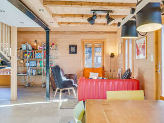 Experience the charm of this cozy chalet, featuring a bright and airy living space with wooden accents and modern furnishings.