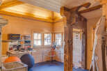 This charming property boasts a warm and inviting interior with beautiful wooden walls and ceilings.