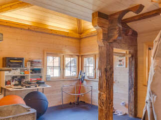 This charming property boasts a warm and inviting interior with beautiful wooden walls and ceilings.