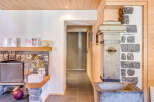 Discover the charm of this unique property, featuring a stunning stone fireplace and a rustic wooden ceiling.