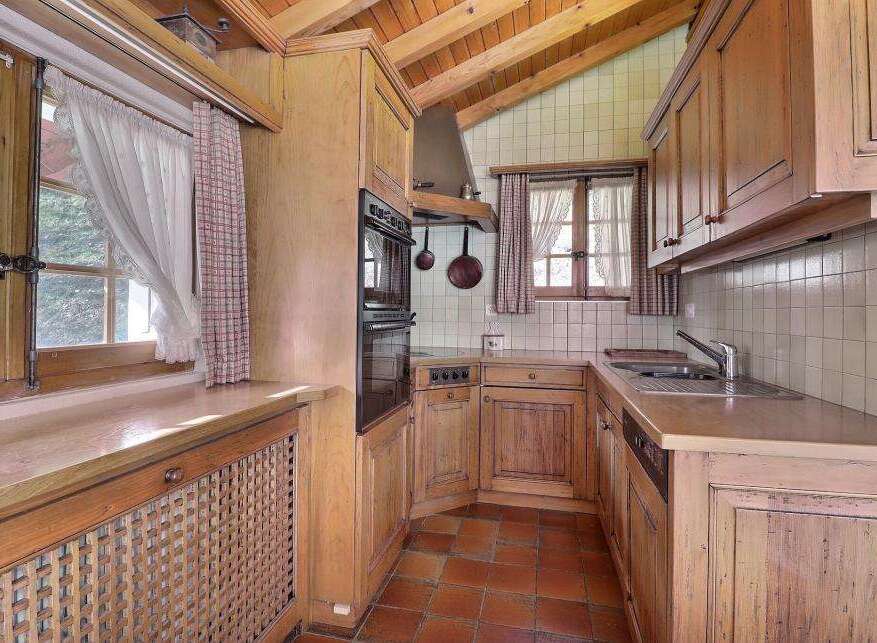 This charming kitchen features a rustic design with wooden cabinets and a cozy atmosphere.