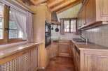 This charming kitchen features a rustic design with wooden cabinets and a cozy atmosphere.