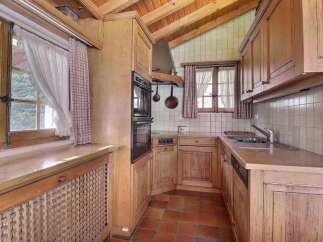 This charming kitchen features a rustic design with wooden cabinets and a cozy atmosphere.