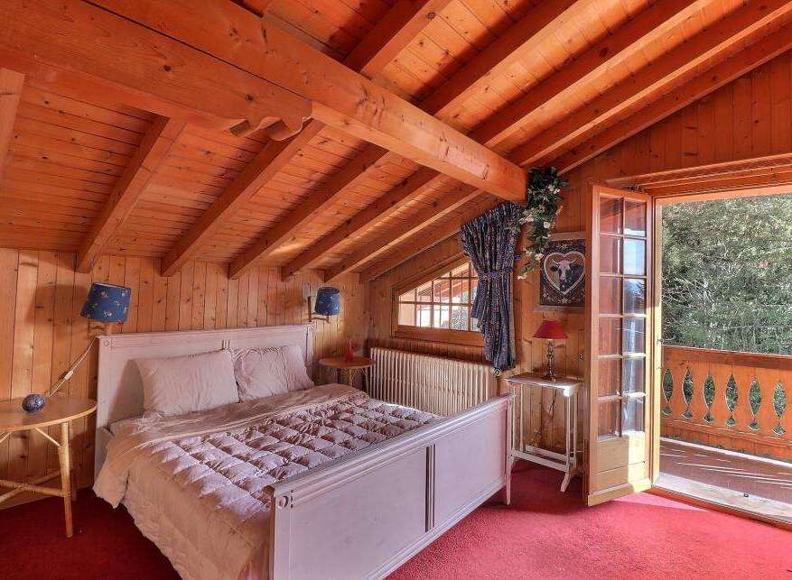 This charming bedroom features a cozy wooden interior, creating a warm and inviting atmosphere.
