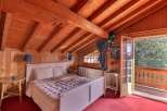 This charming bedroom features a cozy wooden interior, creating a warm and inviting atmosphere.