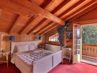This charming bedroom features a cozy wooden interior, creating a warm and inviting atmosphere.