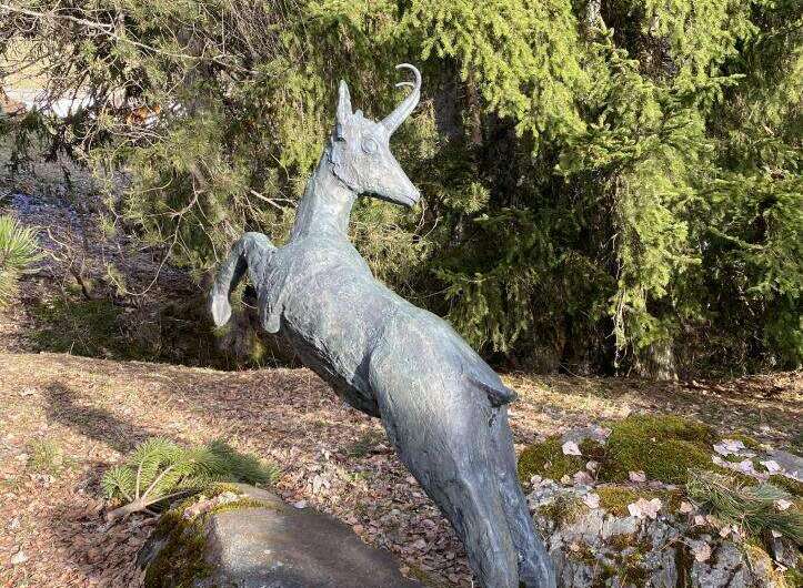 Discover the charm of this unique property, featuring a captivating sculpture of a leaping deer.