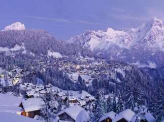 Nestled in a picturesque winter wonderland, this property offers stunning views of snow-capped mountains and a charming village.