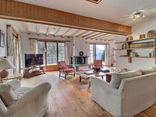 Experience the charm of this inviting living space, featuring a cozy fireplace and stunning mountain views.