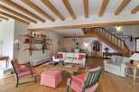 Step into this charming living space, featuring a rustic wooden ceiling and a cozy ambiance.