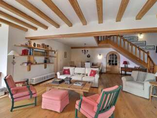 Step into this charming living space, featuring a rustic wooden ceiling and a cozy ambiance.