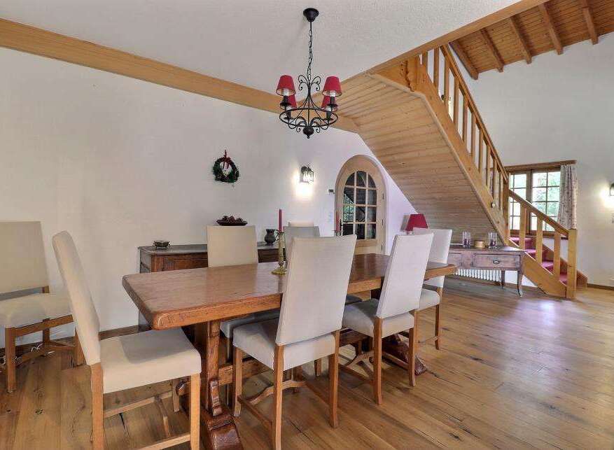 This charming dining room features a rustic wooden table and chairs, perfect for family gatherings.